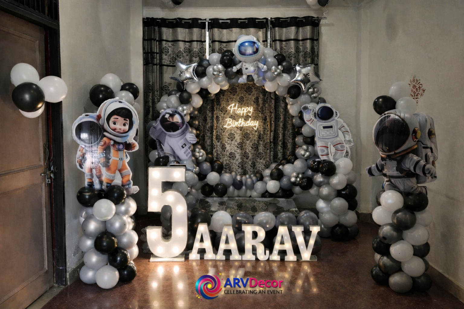 Space Astronaut Kids Birthday Decor With Black And Silver Balloon Arch And Name Lights - birthday decoration by ARV Decor