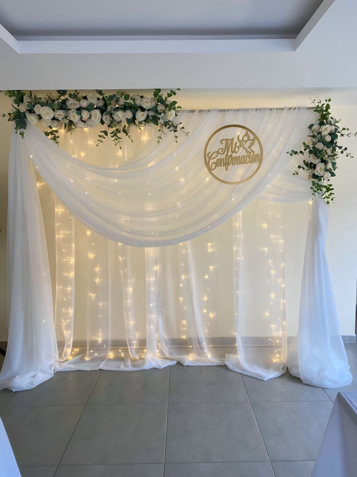 White And Green Confirmation Backdrop With Floral Drapes And Fairy Lights - balloon and flower decoration by ARV Decor
