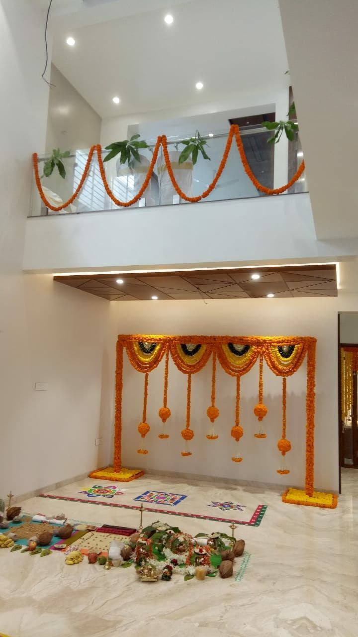 Traditional Marigold Floral Backdrop And Rangoli Decor For Home Pooja Ceremony - balloon and flower decoration by ARV Decor